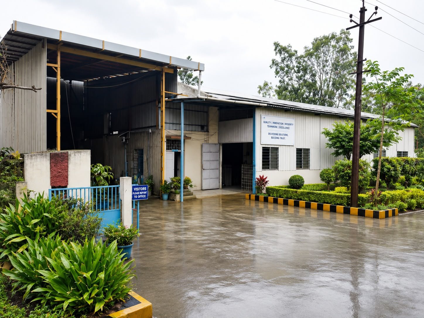 Plant II building of Nashik Autotech Pvt. Ltd. at W-144, MIDC Ambad, Nashik, with visitors sign and garden